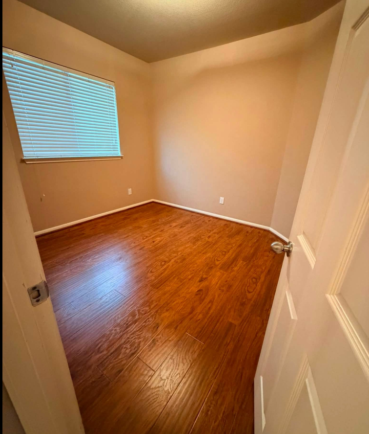 Freshly cleaned bedroom with gleaming hardwood floors after a move-out clean