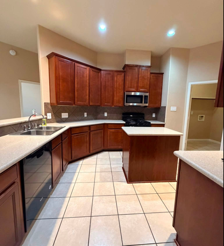 Spotless cherry-wood kitchen cleaned by MV Luxury Cleaning in Houston, TX